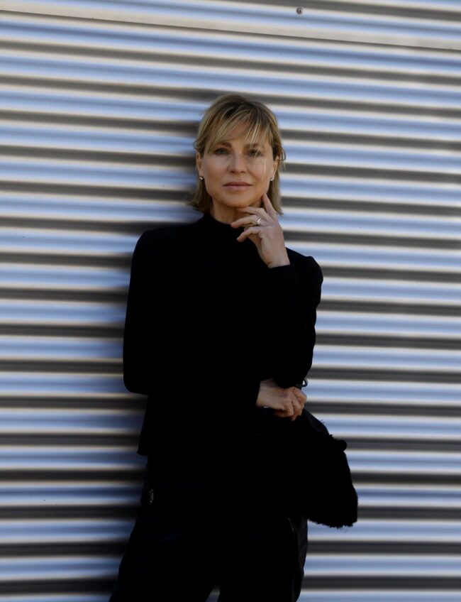 Minimal chic portrait against a striped wall, natural glowing skin — Blandine Lagoutte